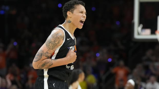 Mercury forward Brittney Griner screams in excitement after a play in a game.
